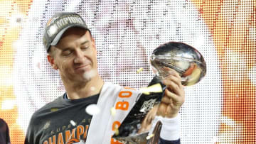 Feb 7, 2016; Santa Clara, CA, USA; Denver Broncos quarterback Peyton Manning (18) looks at the Vince Lombardi Trophy after beating the Carolina Panthers in Super Bowl 50 at Levi