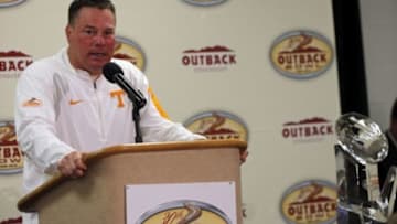 Jan 1, 2016; Tampa, FL, USA; Tennessee Volunteers head coach Butch Jones is presented the trophy as they beat the Northwestern Wildcats in the 2016 Outback Bowl at Raymond James Stadium. Tennessee Volunteers defeated the Northwestern Wildcats 45-6. Mandatory Credit: Kim Klement-USA TODAY Sports