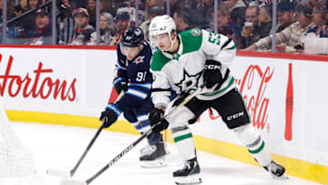 Nov 8, 2022; Winnipeg, Manitoba, CAN; Dallas Stars center Wyatt Johnston (53) shots the puck from Winnipeg Jets center Cole Perfetti (91) in the second period at Canada Life Centre. Mandatory Credit: James Carey Lauder-USA TODAY Sports