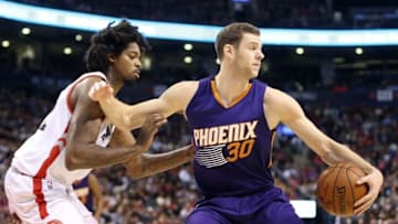 Nov 29, 2015; Toronto, Ontario, CAN; Phoenix Suns forward Jon Leuer (30) controls the ball as he is watched by Toronto Raptors center Lucas Nogueira (92) at Air Canada Centre. The Suns beat the Raptors 107-102. Mandatory Credit: Tom Szczerbowski-USA TODAY Sports