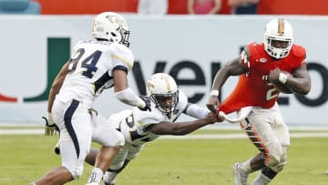 Miami running back Joseph Yearby (2) on a first-down run as Georgia Tech defensive back Lawrence Austin (20) attempts to make the stop in the fourth quarter at Sun Life Stadium in Miami on Saturday, Nov. 21, 2015. Miami won, 38-21. (Al Diaz/Miami Herald/TNS via Getty Images)