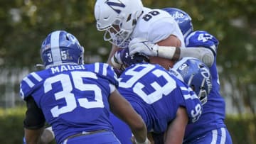 Sep 18, 2021; Durham, North Carolina, USA; Northwestern Wildcats tight end Marshall Lang (88) is wrapped up by Duke Blue Devils linebacker Shaka Heyward (42), defensive end Ben Frye (93) and linebacker Dorian Mausi (35) during the second quarter at Wallace Wade Stadium. Mandatory Credit: William Howard-USA TODAY Sports