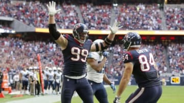 Nov 30, 2014; Houston, TX, USA; Houston Texans defensive end J.J. Watt (99) celebrates with tight end Ryan Griffin (84) after catching a touchdown pass in the fourth quarter against the Tennessee Titans at NRG Stadium. Mandatory Credit: Matthew Emmons-USA TODAY Sports