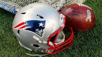 Dec 14, 2014; Foxborough, MA, USA; A New England Patriots helmet and an NFL football are seen on the sidelines during the second half of the New England Patriots 41-13 win over the Miami Dolphins at Gillette Stadium. Mandatory Credit: Winslow Townson-USA TODAY Sports