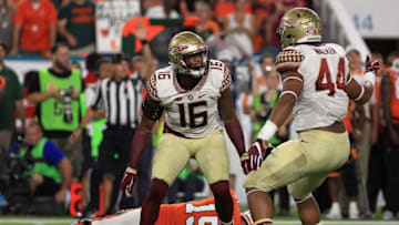 MIAMI GARDENS, FL - OCTOBER 08: Jacob Pugh #16 and DeMarcus Walker #44 of the Florida State Seminoles celebrate a sack on Brad Kaaya #15 of the Miami Hurricanes during a game at Hard Rock Stadium on October 8, 2016 in Miami Gardens, Florida. (Photo by Mike Ehrmann/Getty Images)