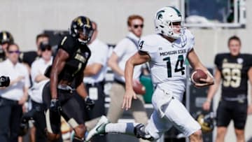 EAST LANSING, MI - SEPTEMBER 09: Quarterback Brian Lewerke #14 of the Michigan State Spartans runs 61 yards for a touchdown while being pursued by defensive back Sam Beal #1 of the Western Michigan Broncos during the first half at Spartan Stadium on September 9, 2017 in East Lansing, Michigan. (Photo by Duane Burleson/Getty Images)