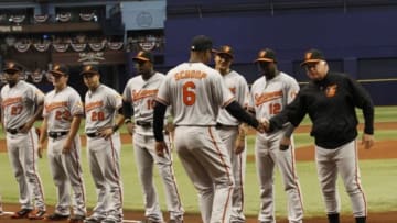 Apr 6, 2015; St. Petersburg, FL, USA; Baltimore Orioles second baseman Jonathan Schoop (6) shakes hands with manager Buck Showalter (26) and teammates as he is introduced before the game against the Tampa Bay Ray at Tropicana Field. Mandatory Credit: Kim Klement-USA TODAY Sports