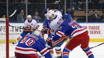 NEW YORK, NEW YORK - JANUARY 21: Alexandar Georgiev #40 and Tony DeAngelo #77 of the New York Rangers defend the net against Casey Cizikas #53 of the New York Islanders at Madison Square Garden on January 21, 2020 in New York City. The Islanders defeated the Rangers 4-2. (Photo by Bruce Bennett/Getty Images)