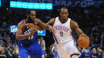 Mar 4, 2015; Oklahoma City, OK, USA; Oklahoma City Thunder forward Serge Ibaka (9) handles the ball against Philadelphia 76ers forward Luc Richard Mbah a Moute (12) during the fourth quarter at Chesapeake Energy Arena. Mandatory Credit: Mark D. Smith-USA TODAY Sports