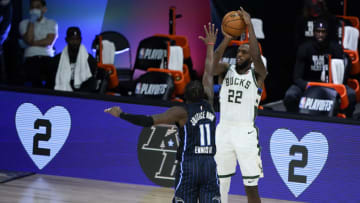 LAKE BUENA VISTA, FLORIDA - AUGUST 24: Khris Middleton #22 of the Milwaukee Bucks shoots over James Ennis III #11 of the Orlando Magic in the first half of Game Four during the first round of the playoffs at The Field House at ESPN Wide World Of Sports Complex on August 24, 2020 in Lake Buena Vista, Florida. NOTE TO USER: User expressly acknowledges and agrees that, by downloading and or using this photograph, User is consenting to the terms and conditions of the Getty Images License Agreement. (Photo by Ashley Landis-Pool/Getty Images)