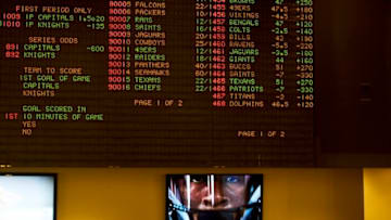 HARRINGTON, DE - JUNE 5: A television monitor displays a football player below a betting odds monitor at the Harrington Raceway and Casino on June 5, 2018 in Harrington, Delaware. Delaware is the first state to launch legal sports betting since the Supreme Court decision to lift a 25-year old federal ban. (Photo by Mark Makela/Getty Images)