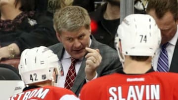 Dec 19, 2015; Pittsburgh, PA, USA; Carolina Hurricanes head coach Bill Peters (middle) talks with center Joakim Nordstrom (42) and defenseman Jaccob Slavin (74) during a timeout against the Pittsburgh Penguins during the first period at the CONSOL Energy Center. Mandatory Credit: Charles LeClaire-USA TODAY Sports