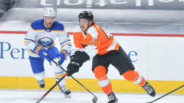 PHILADELPHIA, PA - JANUARY 19: Morgan Frost #48 of the Philadelphia Flyers skates past Taylor Hall #4 of the Buffalo Sabres in the first period at Wells Fargo Center on January 19, 2021 in Philadelphia, Pennsylvania. (Photo by Drew Hallowell/Getty Images)