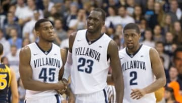 Jan 13, 2016; Villanova, PA, USA; Villanova Wildcats forward Daniel Ochefu (23) is helped off the court by forward Darryl Reynolds (45) and forward Kris Jenkins (2) after an injury during the second half against the Marquette Golden Eagles at The Pavilion. Villanova won 83-68. Mandatory Credit: Bill Streicher-USA TODAY Sports