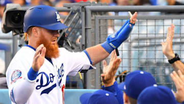 LOS ANGELES, CA - MAY 22: Justin Turner #10 of the Los Angeles Dodgers is greeted in the dugout after scoring a run in the first inning of the game against the Colorado Rockies at Dodger Stadium on May 22, 2018 in Los Angeles, California. (Photo by Jayne Kamin-Oncea/Getty Images)