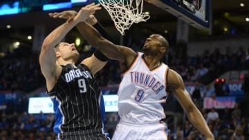 Feb 3, 2016; Oklahoma City, OK, USA; Oklahoma City Thunder forward Serge Ibaka (9) fouls Orlando Magic center Nikola Vucevic (9) on a shot attempt during the second quarter at Chesapeake Energy Arena. Mandatory Credit: Mark D. Smith-USA TODAY Sports