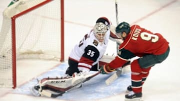 Jan 25, 2016; Saint Paul, MN, USA; Arizona Coyotes goalie Louis Domingue (35) makes a save on a shot by Minnesota Wild center Mikko Koivu (9) in the shootout at Xcel Energy Center. The Coyotes win 2-1 in an overtime shootout. Mandatory Credit: Marilyn Indahl-USA TODAY Sports