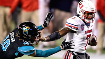 Dec 26, 2020; Orlando, FL, USA; Liberty Flames quarterback Malik Willis (7) runs the ball in for a touchdown as Coastal Carolina Chanticleers safety Alex Spillum (10) defends during the second half of the Cure Bowl at Camping World Stadium. Mandatory Credit: Douglas DeFelice-USA TODAY Sports