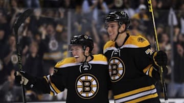 Sep 24, 2015; Boston, MA, USA; Boston Bruins center Austin Czarnik (61) celebrates a goal with defenseman Brandon Carlo (73) during the third period again the New York Rangers at TD Garden. Mandatory Credit: Bob DeChiara-USA TODAY Sports