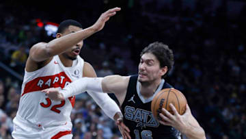 SAN ANTONIO, TX - NOVEMBER 5: Cedi Osman #16 of the San Antonio Spurs drives on Otto Porter Jr. #32 of the Toronto Raptors in the first half at Frost Bank Center on November 5, 2023 in San Antonio, Texas. NOTE TO USER: User expressly acknowledges and agrees that, by downloading and or using this photograph, User is consenting to terms and conditions of the Getty Images License Agreement. (Photo by Ronald Cortes/Getty Images)