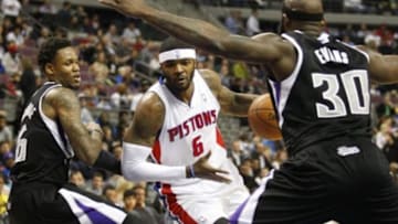 Mar 11, 2014; Auburn Hills, MI, USA; Detroit Pistons small forward Josh Smith (6) dribbles between Sacramento Kings shooting guard Ben McLemore (16) and power forward Reggie Evans (30) during the first quarter at The Palace of Auburn Hills. Mandatory Credit: Raj Mehta-USA TODAY Sports