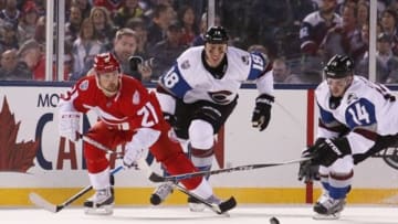 Feb 27, 2016; Denver, CO, USA; Detroit Red Wings left wing Tomas Tatar (21) chases the puck with Colorado Avalanche left wing Blake Comeau (14)and center Shawn Matthias (18) in the third period during a Stadium Series hockey game at Coors Field. Mandatory Credit: Isaiah J. Downing-USA TODAY Sports