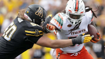 BOONE, NC - SEPTEMBER 17: Beau Nunn #50 of the Appalachian State Mountaineers tries to tackle Mike Smith #57 of the Miami Hurricanes after he intercepts the ball during their game at Kidd Brewer Stadium on September 17, 2016 in Boone, North Carolina. (Photo by Streeter Lecka/Getty Images)