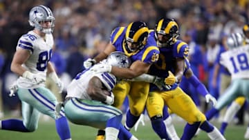 LOS ANGELES, CA - JANUARY 12: Ndamukong Suh #93 of the Los Angeles Rams tackles Ezekiel Elliott #21 of the Dallas Cowboys in the third quarter in the NFC Divisional Playoff game at Los Angeles Memorial Coliseum on January 12, 2019 in Los Angeles, California. (Photo by Sean M. Haffey/Getty Images)