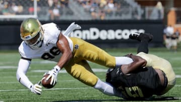 WINSTON SALEM, NC - SEPTEMBER 22: Chuck Wade Jr. #9 of the Wake Forest Demon Deacons tackles Alize Mack #86 of the Notre Dame Fighting Irish during their game at BB&T Field on September 22, 2018 in Winston Salem, North Carolina. (Photo by Streeter Lecka/Getty Images)