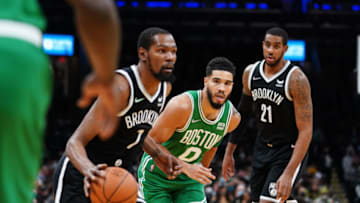 Nov 24, 2021; Boston, Massachusetts, USA; Boston Celtics forward Jayson Tatum (0) defends against Brooklyn Nets forward Kevin Durant (7) in the first half at TD Garden. Mandatory Credit: David Butler II-USA TODAY Sports