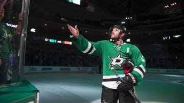Mar 29, 2016; Dallas, TX, USA; Dallas Stars defenseman Alex Goligoski (33) tosses a puck to the crowd after being named the number two star in the win over the Nashville Predators at the American Airlines Center. The Stars defeat the Predators 5-2. Mandatory Credit: Jerome Miron-USA TODAY Sports