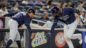 NEW YORK, NY - SEPTEMBER 27: Adeiny Hechavarria #11 of the Tampa Bay Rays (R) slaps hands with Charlie Montoyo #25 after hitting a solo home run in the fifth innning at Yankee Stadium on September 27, 2017 in the Bronx borough of New York City. (Photo by Abbie Parr/Getty Images)