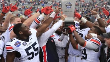 Dec 30, 2015; Birmingham, AL, USA; Auburn Tigers head coach Gus Malzahn along with his team hold up the Birmingham Bowl trophy after they defeated Memphis Tigers 31-10 in the 2015 Birmingham Bowl at Legion Field. Mandatory Credit: Marvin Gentry-USA TODAY Sports