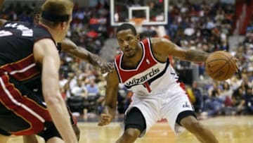 Apr 14, 2014; Washington, DC, USA; Washington Wizards forward Trevor Ariza (1) dribbles the ball as Miami Heat center Justin Hamilton (7) defends in the second quarter at Verizon Center. The Wizards won 114-93. Mandatory Credit: Geoff Burke-USA TODAY Sports