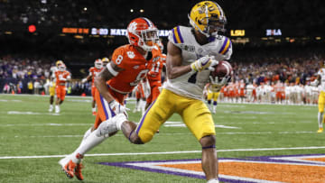 NEW ORLEANS, LA - JANUARY 13: Wide Receiver Ja'Marr Chase #1 of the LSU Tigers makes a catch over Cornerback A.J. Terrell #8 of the Clemson Tigers for a touchdown during the College Football Playoff National Championship game at the Mercedes-Benz Superdome on January 13, 2020 in New Orleans, Louisiana. LSU defeated Clemson 42 to 25. (Photo by Don Juan Moore/Getty Images)