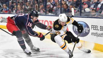 COLUMBUS, OH - MAY 2: Pierre-Luc Dubois #18 of the Columbus Blue Jackets attempts to knock Brandon Carlo #25 of the Boston Bruins off the puck during the third period in Game Four of the Eastern Conference Second Round during the 2019 NHL Stanley Cup Playoffs on May 2, 2019 at Nationwide Arena in Columbus, Ohio. (Photo by Jamie Sabau/NHLI via Getty Images)