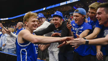 Mar 5, 2022; St. Louis, MO, USA; Drake Bulldogs guard Tucker Devries (12) celebrates with fans after scoring the game winning point in overtime against the Missouri State Bears in the semifinals of the Missouri Valley Conference Tournament at Enterprise Center. Mandatory Credit: Jeff Curry-USA TODAY Sports