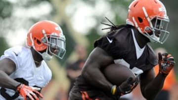 Jul 26, 2014; Berea, OH, USA; Cleveland Browns running back Isaiah Crowell (30) is chased by cornerback Justin Gilbert (21) during training camp at the Cleveland Browns training facility. Mandatory Credit: Ken Blaze-USA TODAY Sports