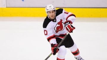 Nov 25, 2014; Vancouver, British Columbia, CAN; New Jersey Devils defenseman Peter Harrold (10) shoots the puck during the third period against the Vancouver Canucks at Rogers Arena.The Vancouver Canucks won 2-0. Mandatory Credit: Anne-Marie Sorvin-USA TODAY Sports