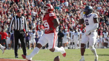 Oklahoma Sooners running back Tawee Walker (29) runs for a touchdown beside TCU Horned Frogs linebacker Jamoi Hodge (6) during a college football game between the University of Oklahoma Sooners (OU) and the TCU Horned Frogs at Gaylord Family-Oklahoma Memorial Stadium in Norman, Okla., Friday, Nov. 24, 2023.