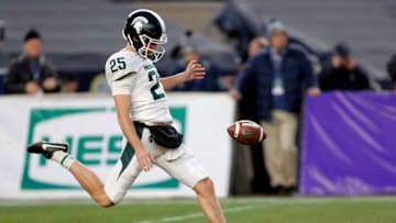 NEW YORK, NY - DECEMBER 27: Punter Jake Hartbarger #25 of the Michigan State Spartans punts against the Wake Forest Demon Deacons during the first half of the New Era Pinstripe Bowl at Yankee Stadium on December 27, 2019 in the Bronx borough of New York City. (Photo by Adam Hunger/Getty Images)