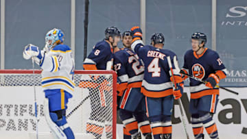 UNIONDALE, NEW YORK - MARCH 06: Anders Lee #27 of the New York Islanders scores at 2:15 of the third period against Carter Hutton #40 of the Buffalo Sabres at the Nassau Coliseum on March 06, 2021 in Uniondale, New York. (Photo by Bruce Bennett/Getty Images)