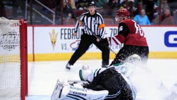 Feb 18, 2016; Glendale, AZ, USA; Arizona Coyotes center Max Domi (16) scores on Dallas Stars goalie Antti Niemi (31) during the second period at Gila River Arena. Mandatory Credit: Matt Kartozian-USA TODAY Sports