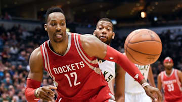 Feb 29, 2016; Milwaukee, WI, USA; Houston Rockets center Dwight Howard (12) and Milwaukee Bucks center Greg Monroe (15) reach for a loose ball in the first quarter at BMO Harris Bradley Center. Mandatory Credit: Benny Sieu-USA TODAY Sports
