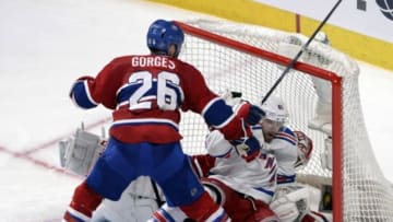 May 27, 2014; Montreal, Quebec, CAN; Montreal Canadiens defenseman Josh Gorges (26) pushes New York Rangers forward Rick Nash (61) on teammate goalie Dustin Tokarski (35) during the third period in game five of the Eastern Conference Final of the 2014 Stanley Cup Playoffs at the Bell Centre. Mandatory Credit: Eric Bolte-USA TODAY Sports