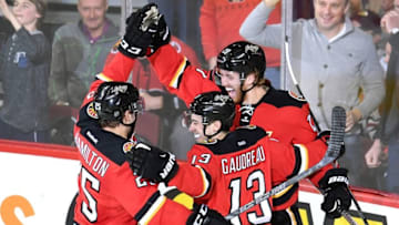 Mar 26, 2016; Calgary, Alberta, CAN; Calgary Flames defenseman Dougie Hamilton (27) celebrates his second period goal with centre Freddie Hamilton (25) and left wing Johnny Gaudreau (13) against the Chicago Blackhawks at Scotiabank Saddledome. Mandatory Credit: Candice Ward-USA TODAY Sports