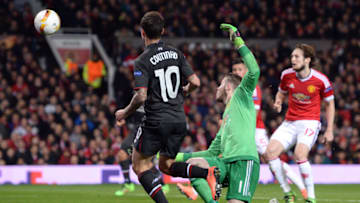 Liverpool's Brazilian midfielder Philippe Coutinho (L) shoots past Manchester United's Spanish goalkeeper David de Gea (2nd L) to score their first goal during the UEFA Europa League round of 16, second leg football match between Manchester United and Liverpool at Old Trafford in Manchester, north west England on March 17, 2016. / AFP / OLI SCARFF (Photo credit should read OLI SCARFF/AFP/Getty Images)