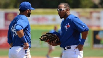 Mar 29, 2015; Dunedin, FL, USA; Toronto Blue Jays outfielder Jose Bautista (19) and first baseman Edwin Encarnacion (10) talk between innings during the spring training game against the Baltimore Orioles at Florida Auto Exchange Park. Mandatory Credit: Jonathan Dyer-USA TODAY Sports