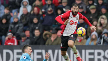 SOUTHAMPTON, ENGLAND - DECEMBER 10: Laurent Koscielny of Arsenal goes down after clashing with Charlie Austin of Southampton during the Premier League match between Southampton and Arsenal at St Mary's Stadium on December 9, 2017 in Southampton, England. (Photo by Richard Heathcote/Getty Images)