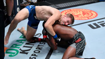 LAS VEGAS, NEVADA - OCTOBER 02: In this handout photo provided by UFC,(L-R) Kyle Daukaus attempts to submit Kevin Holland in their middleweight bout during the UFC Fight Night event at UFC APEX on October 02, 2021 in Las Vegas, Nevada. (Photo by Jeff Bottari/Zuffa LLC via Getty Images)